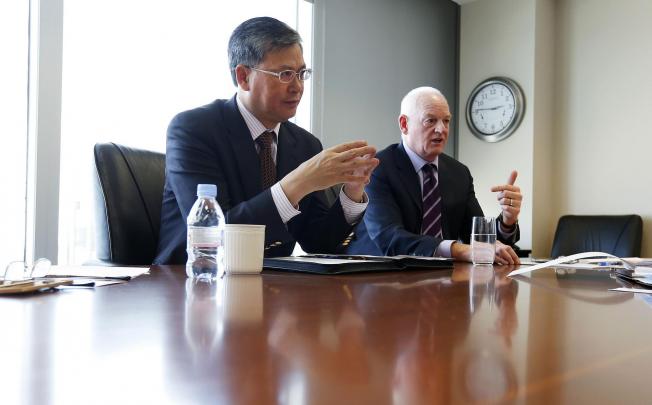 Li Fanrong of CNOOC and Nexen's Kevin Reinhart. Photo: Reuters