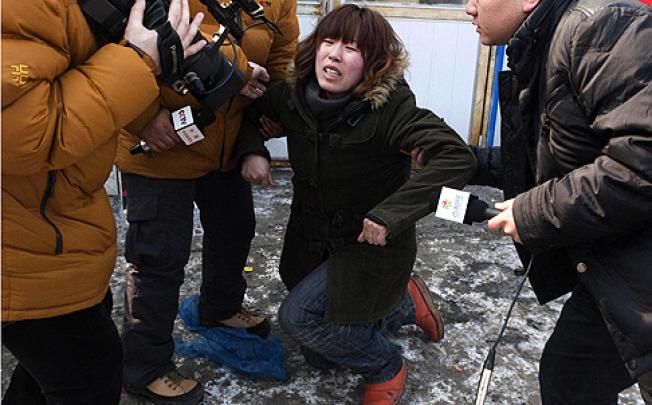 The baby's aunt weeps and pleads for its safe return in Changchun on Tuesday. Photo: SCMP pictures