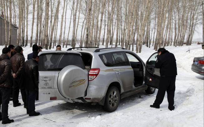 Police collect evidence yesterday from the SUV stolen from the dead boy's father. Photo: Xinhua