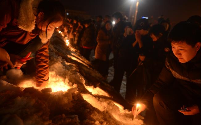Local residents gather to mourn a baby who was strangled to death by a car thief in Changchun on March 5, 2013. Photo: Xinhua