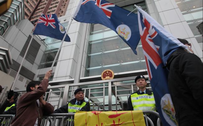 Protesters display Hong Kong colonial flags outside the central government's liaison office on January 1. Photo: SCMP Pictures
