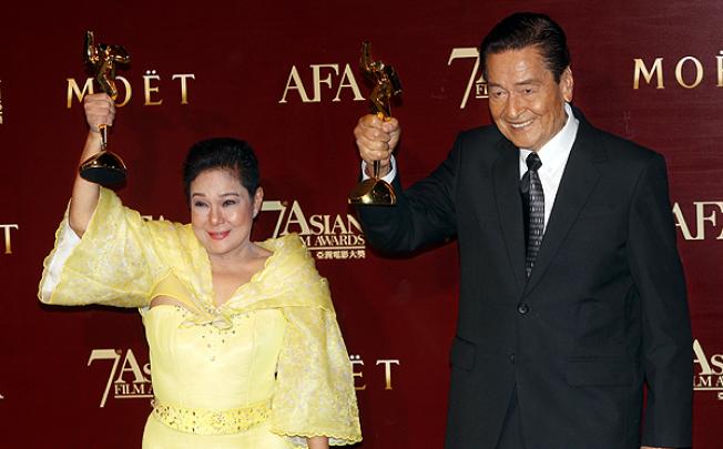 Philippines' Nora Aunor and Eddie Garcia pose with their trophies after winning the Best Actress and Best Actor Award at the Asian Film Awards. Photo: Sam Tsang
