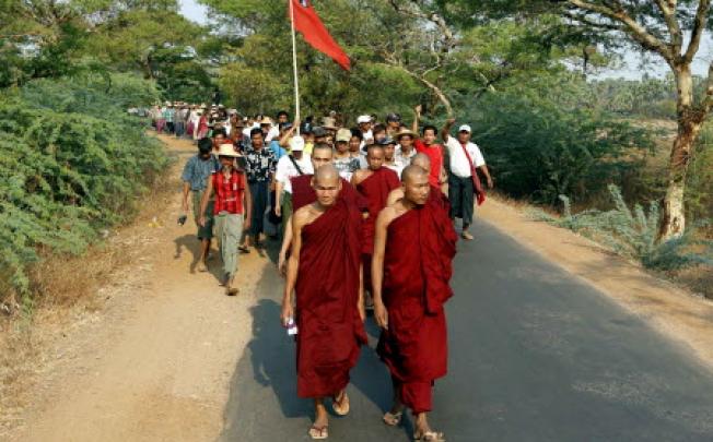 Buddhist monks and supporters in Myanmar. Two people including a Buddhist monk were killed and at least three mosques destroyed after rioting in central Myanmar, police confirmed on Thursday.