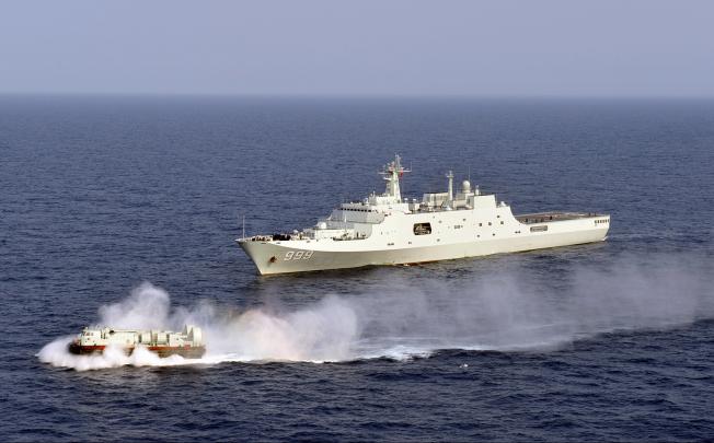 Chinese Navy's amphibious landing ship Jinggangshan is seen during a training with a hovercraft in waters near Hainan Province on March 20, 2013. Photo: Xinhua