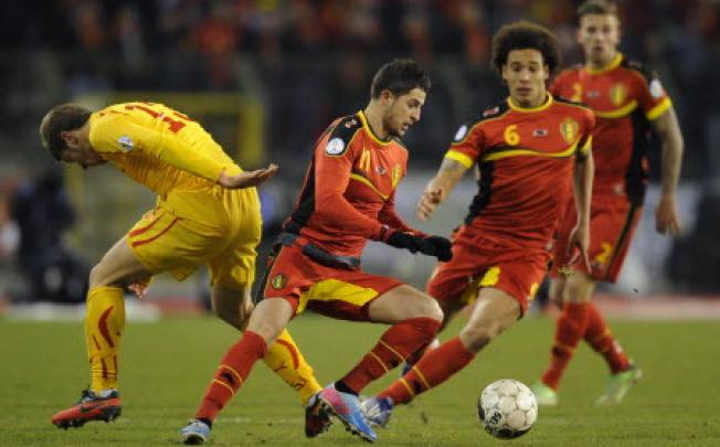 Macedonia's defender Stefan Ristovski (L) and Belgium's forward Kevin Mirallas (C) fight for the ball during the 2014 World Cup qualifying football match between Belgium and Macedonia. Photo: AFP 