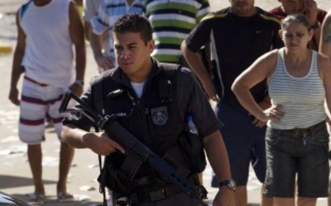 A heavily-armed Brazilian policeman on duty in San Paolo. Photo: AP