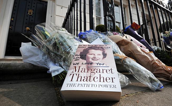 A book and floral tributes are left in honour of former British Prime Minister Margaret Thatcher outside her home in central London. Photo: AFP