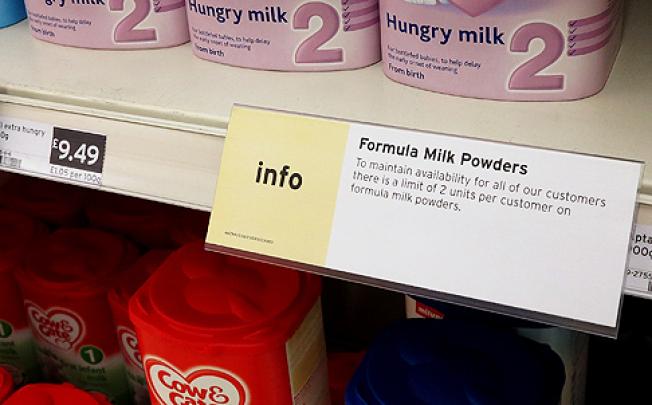 A sign limiting the purchase of baby milk formula powder hangs on the shelf in a supermarket in London, on Wednesday. Photo: AP