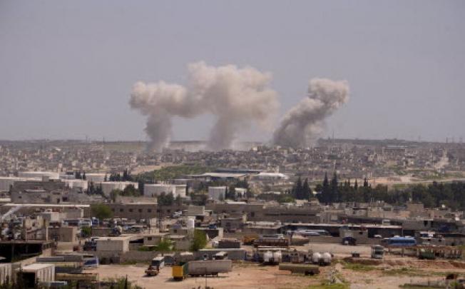 Smoke rises from Sheikh Saeed on the Airport Road near Aleppo city. Forces loyal to Syria's President Bashar al-Assad began military operations towards Sheikh Saeed to pave the way for their troops to enter. Photo: Reuters