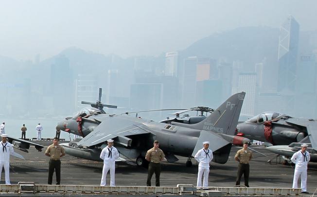 American sailors and marines stand on the deck of the amphibious assault vessel USS Peleliu, which has tied up In Victoria harbour with the landing vessels USS Rushmore and USS Green Bay. Photo: Dickson Lee