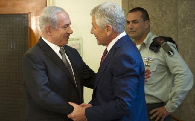Israeli Prime Minister Benjamin Netanyahu, left, welcomes U.S. Secretary of Defense Chuck Hagel at his office in Jerusalem, on Tuesday. Photo: AP
