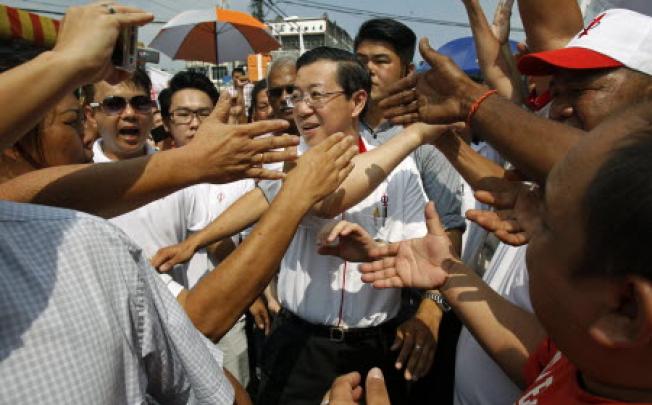 Chief Minister of Penang state Lim Guan Eng (centre) is welcomed by supporters as he arrives for an election campaign rally in Klang, outside Kuala Lumpur on Wednesday. Police says election violence is falling.