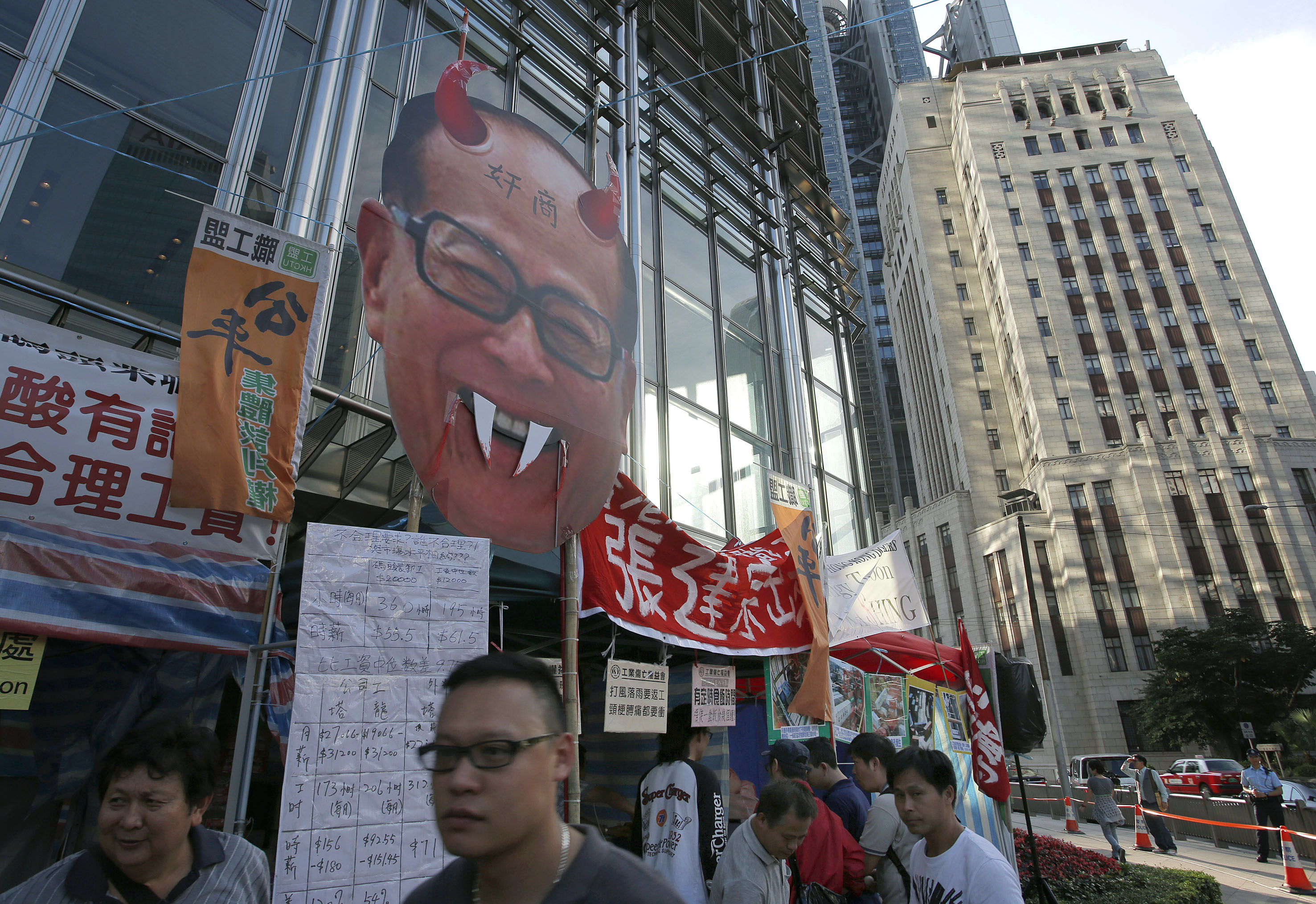 A defaced portrait of Hong Kong billionaire Li Ka-shing is placed outside Cheung Kong Centre. Photo: AP