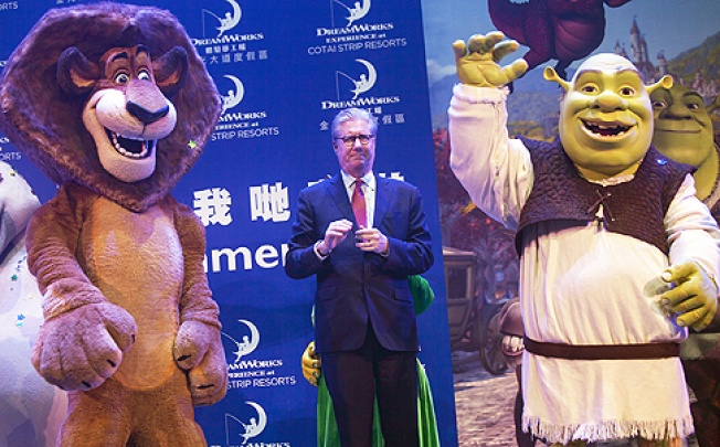 Edward Tracy, President and CEO of Sands China, stands in between DreamWorks animation characters Alex and Shrek, at the Venetian casino, Macau, on Tuesday. Photo: EPA