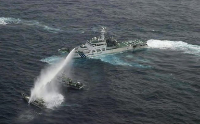 A Japanese coast guard ship turns its water cannon on a boat carrying Taiwanese activists 32km from the disputed islands. Photo: Reuters