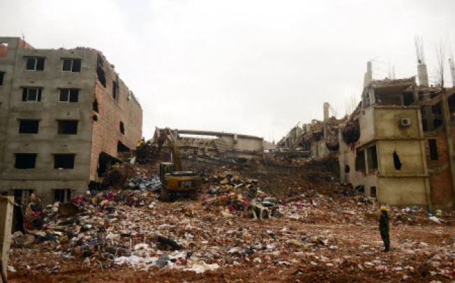 Excavators clear debris as rescue and army personnel continue recovery operations at the site of the eight-storey building collapse in Savar, on the outskirts of Dhaka, on Saturday. Photo: AFP