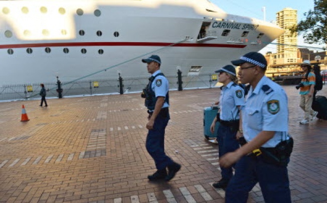Police arrive at Sydney's Circular Quay after two passengers fell overboard from the cuise ship Carnival Spirit as it returned to Sydney from a Pacific cruise. Photo: AFP