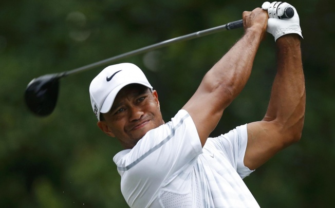 Tiger Woods hits from the 11th tee during The Players Championship at TPC Sawgrass. Woods went on to win the tournament. Photo: Reuters