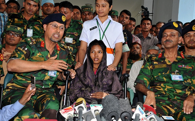 A young female garment worker meets with the media at a hospital in Savar, Dhaka. Rescuers found Reshma clinging to life sandwiched between two floors of the collapsed eight-storey building. Photo: Xinhua