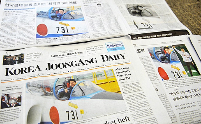 South Korean newspaper front pages show Japanese Prime Minister Shinzo Abe seated inside a military jet trainer on Sunday. Photo: AFP
