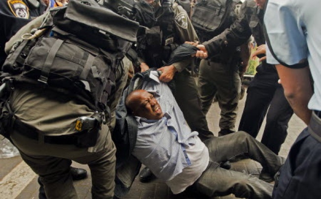 Israeli security forces arrest a Palestinian man during a demonstration in Jerusalem. Israel is set to ‘legalise’ wildcat settler outposts, an NGO said on Thursday. Photo: AFP