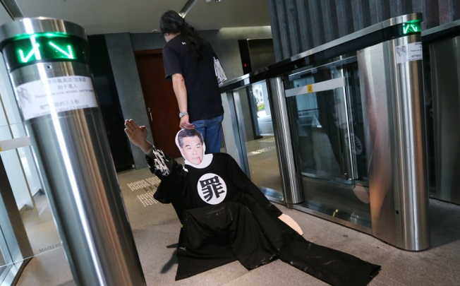 Leung Kwok-hung drags a mannequin of Leung Chun-ying into Legco after his protest. Photo: Sam Tsang