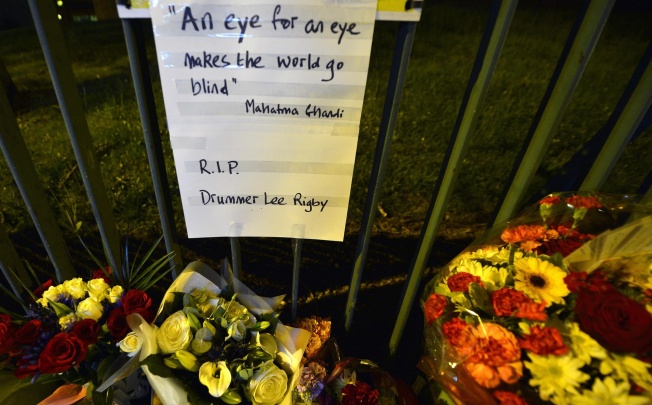 Flowers at the barracks with a message in memory of Lee Rigby - one of his killers said it was an "eye for an eye". Photo: Reuters