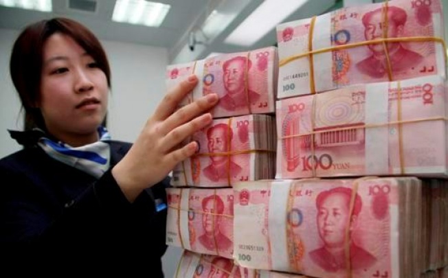 China has eased controls on the yuan to gradually increase the global use of the currency, which has risen to a record high. Photo: Xinhua