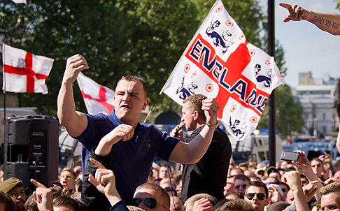 A supporter of the far-right English Defence League (EDL) gestures near Downing Street during a protest. Photo: AFP