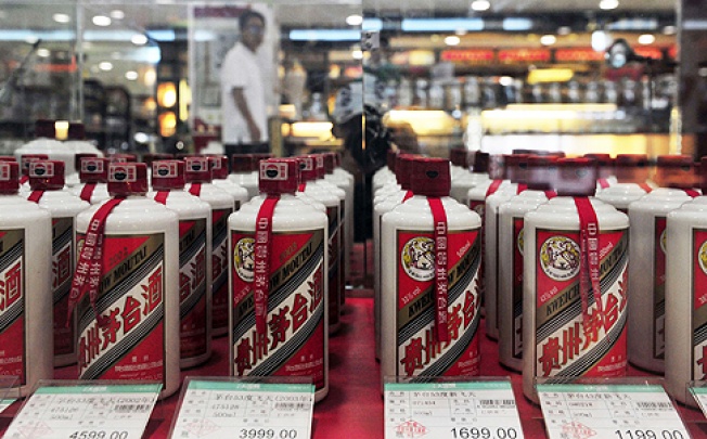 A customer walks past a glass case displaying Maotai liquor, a form of baijiu, at a supermarket in Shenyang, Liaoning province. Photo: Reuters