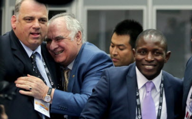 The president of the International wrestling federation Nenad Lalovic (left) is congratulated by an unidentified colleague after the IOC presentation of wrestling as a candidate sports for 2020 Olympics in St.Petersburg. Photo: AFP