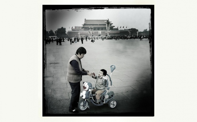 An elderly woman gives her grandson a sausage in Tiananmen Square. While the mainland's elderly population is the fastest-growing in the world, the younger population is in decline. Photo: Simon Song