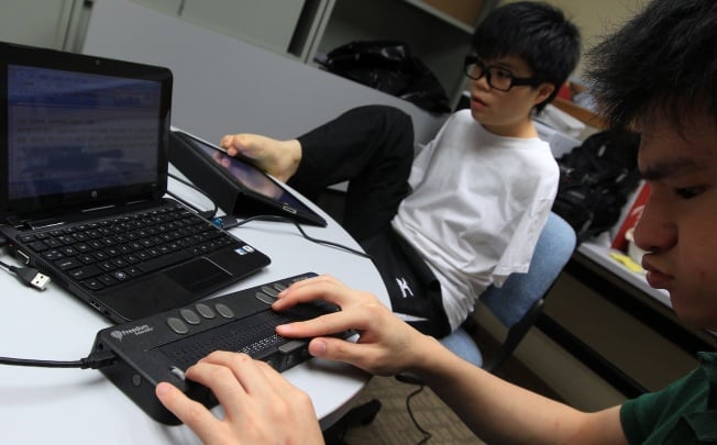 Physically handicapped and visually impaired students demonstrating their E-learning applications. Photo: Jonathan Wong