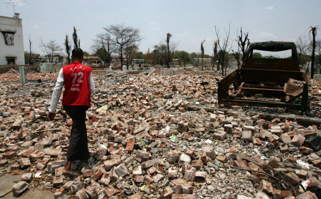 A man walks in a site where a building once stood before sectarian violence between ethnic Rakhine Buddhists and Muslim Rohingya in western Myanmar. Photo: AP