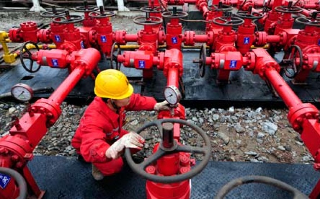 A worker checks the valves in a shale gas plant in China. Photo: Reuters 