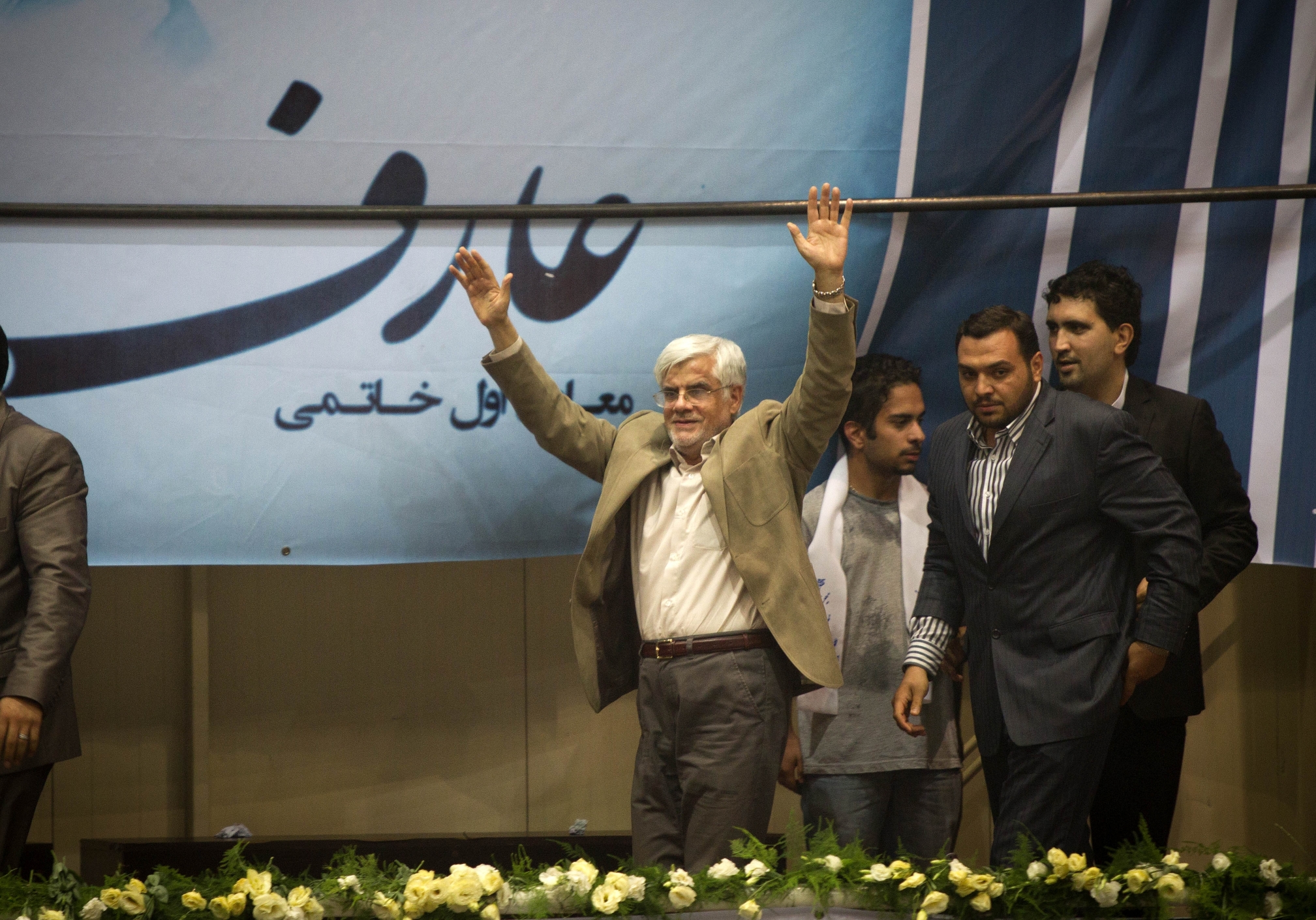 Iranian reformist presidential candidate Mohammad-Reza Aref (left) waves to supporters during his campaign rally in Tehran in Iran. Photo: Xinhua.