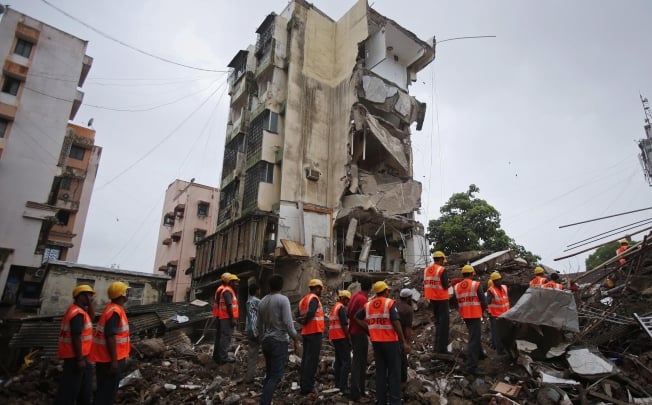 Rescue workers search through rubble at the site of a collapsed residential building in Mumbai. Photo: Reuters