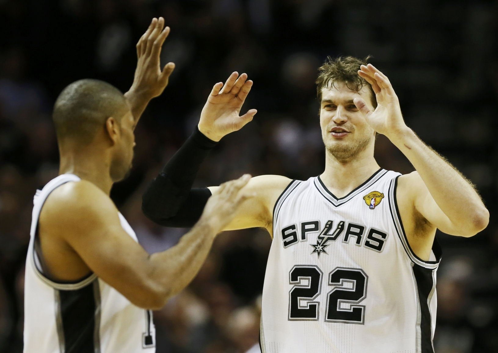 San Antonio Spurs' Tiago Splitter (right) celebrates with teammate Gary Neal against the Miami Heat in the third quarter during Game 3 of their NBA Finals basketball playoff in San Antonio, Texas. Photo: Reuters