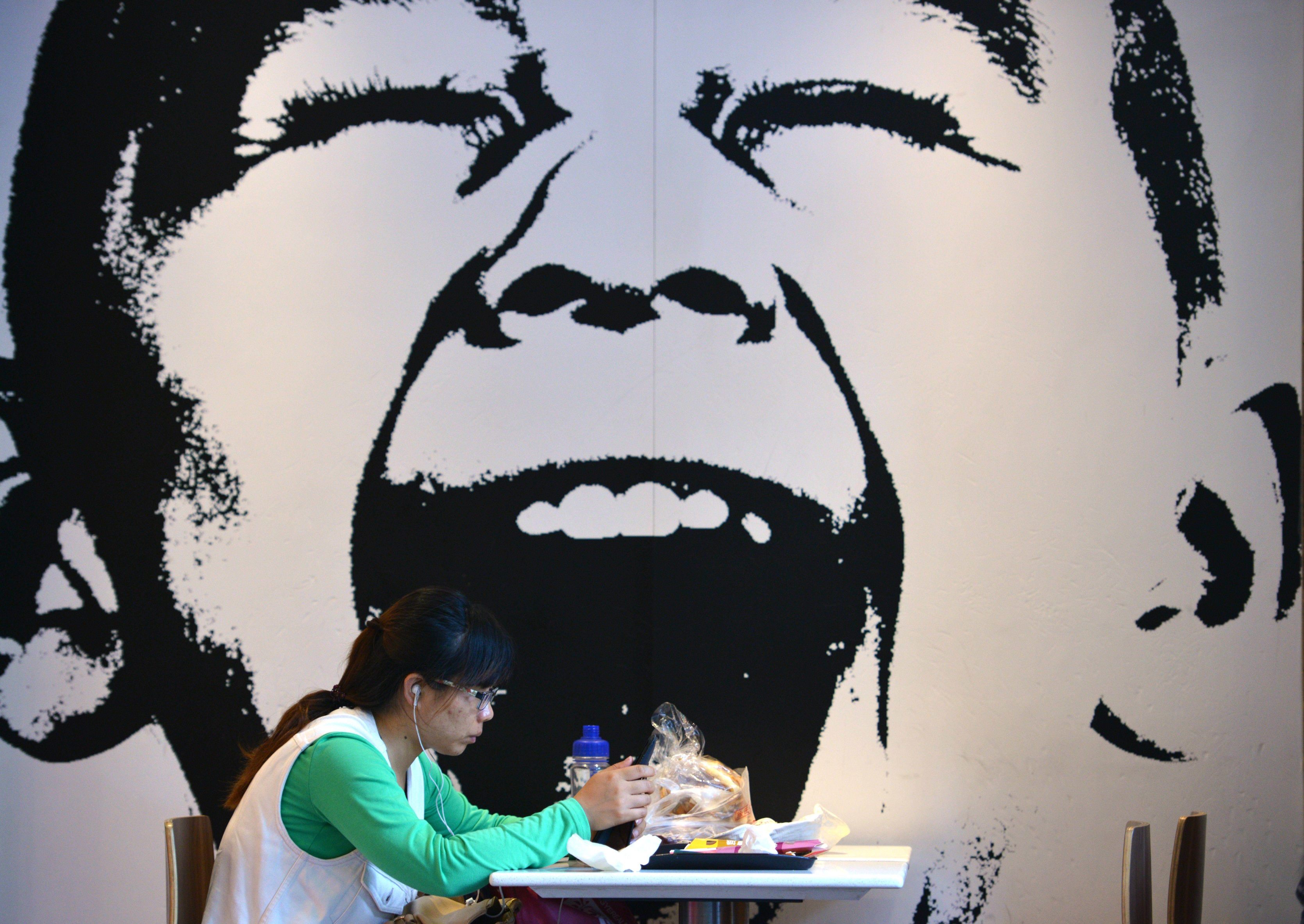 A woman eats at a fast food restaurant in Shanghai. Photo: AFP