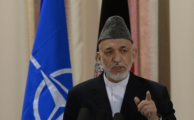 Afghan President Hamid Karzai speaks during a security handover ceremony at a military academy outside Kabul on Tuesday. Photo: AFP