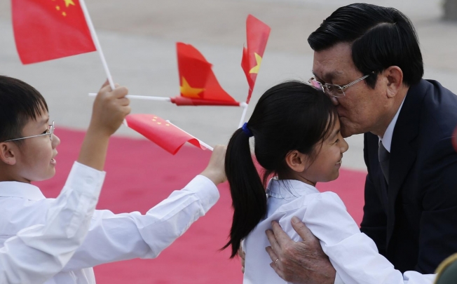 President Truong Tan Sang kisses a girl during a welcoming ceremony hosted by President Xi Jinping. Photo: Reuters