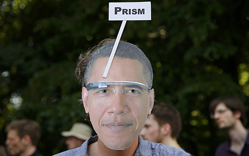 A German protester wears a mask with the portrait of US President Barack Obama sporting Google Glass during a protest in Berlin on Wednesday. Photo: Reuters