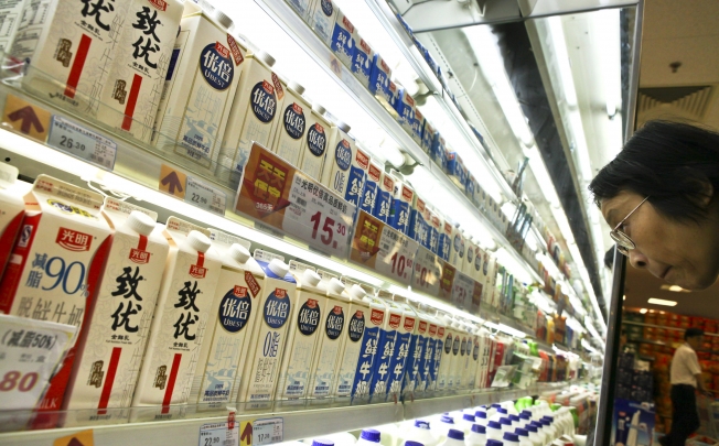 Customers look over products sold by China Bright Dairy, which will see its 51 per cent stake in Synlait diluted to 40 per cent stake after a New Zealand listing. Photo: AP