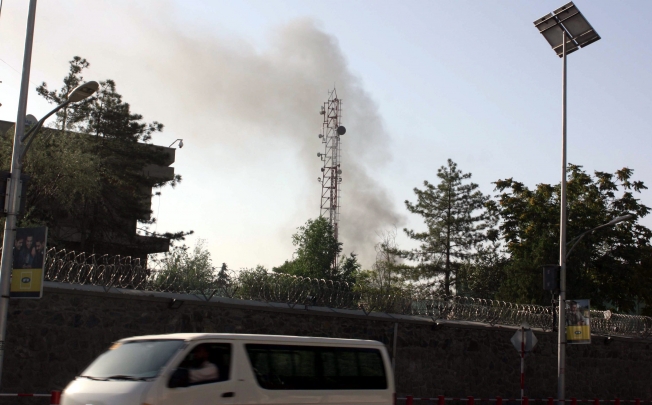 Smoke billows from the scene of gunfight between Taliban militants and Afghan security officials near the Presidential palace in Kabul. Photo: EPA