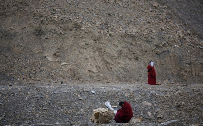 Monks chant mantras at the site near Dzamthang Jonang monastery in Barma where a woman died on May 16 in a self-immolation protest against Beijing. Photo: Reuters