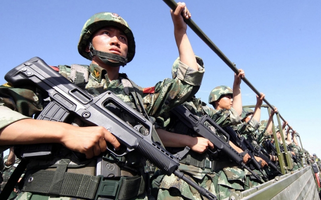 An anti-terrorism force including police and armed police attend an exercise in Hami, Xinjiang, yesterday. Photo: AFP