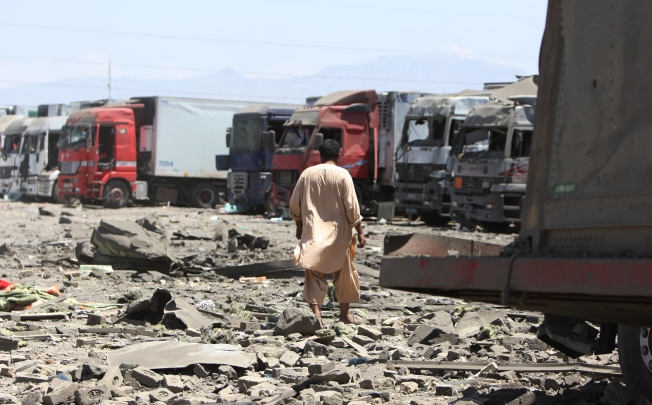 An Afghan man walks at the site of a suicide attack in Kabul. Photo: Xinhua