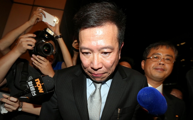 Peter Chan leaves the court amid a media scrum. Photo: Sam Tsang