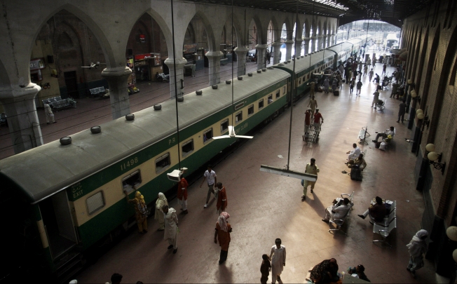 Passengers board a train at the Lahore railway station in Pakistan. Photo: AP