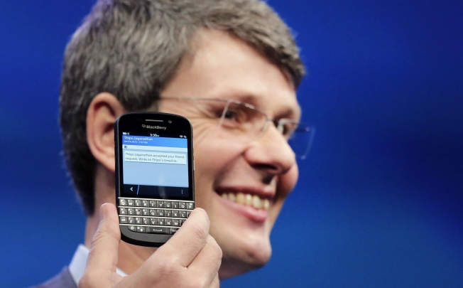 BlackBerry Chief Executive Thorsten Heins shows off the company’s latest smartphone at a news conference earlier this year, has said the company is on the right track and just needs more time. Photo: AP